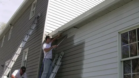 Damaged vinyl siding needing surface repair before painting — professional preparation by ProCut Paint for paint vinyl siding projects