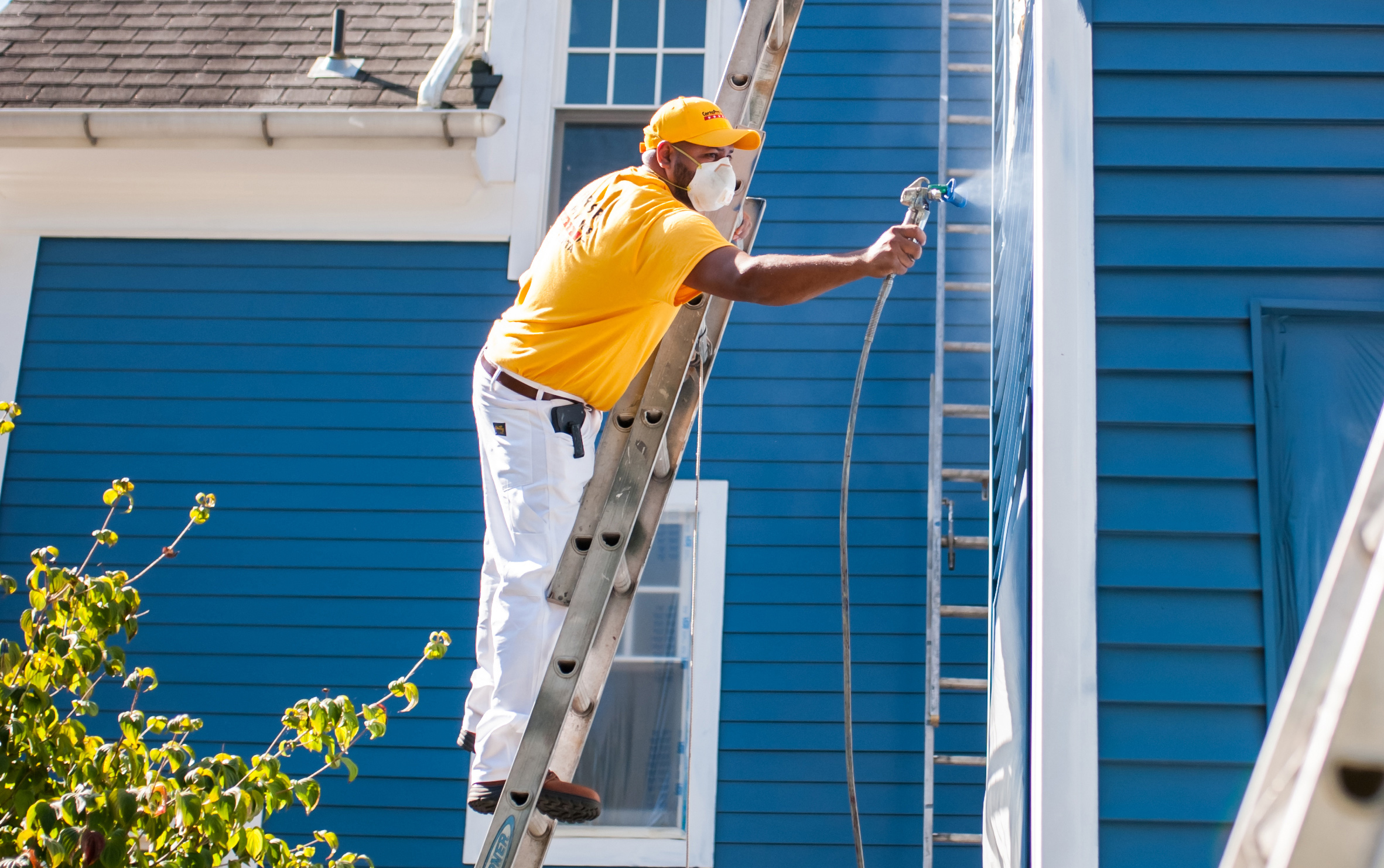 Professional commercial exterior painting contractors working on a business building.