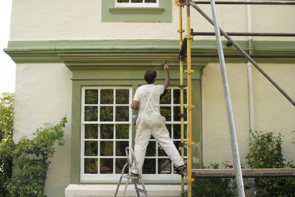 Courtice exterior painting team applying high-quality paint to a home’s exterior